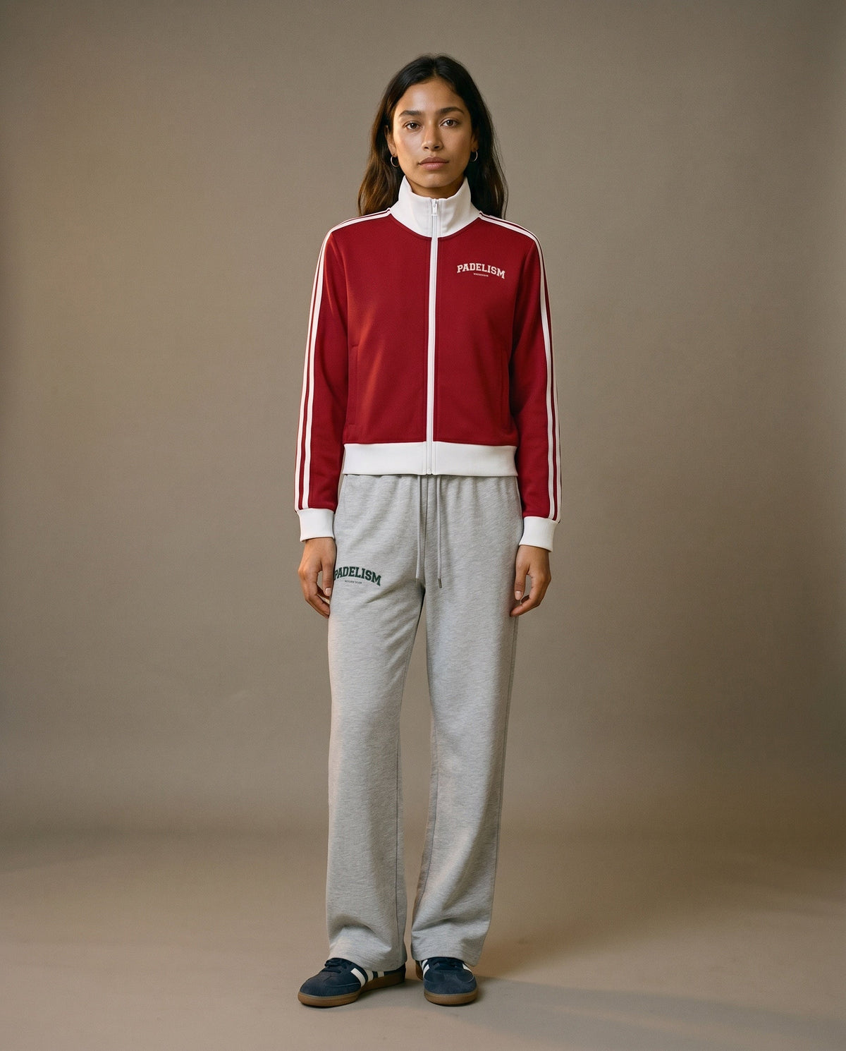 Red track jacket with white zipper, stand collar, and white side stripe detailing