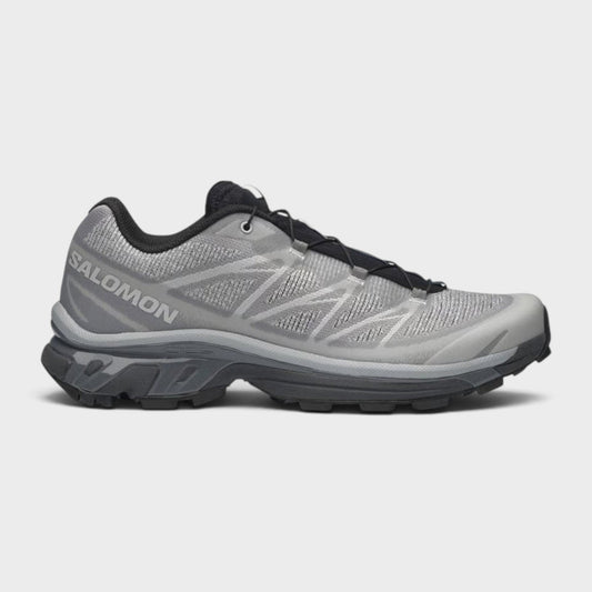 Gray lace-up trail shoes with black laces and chunky rubber tread sole