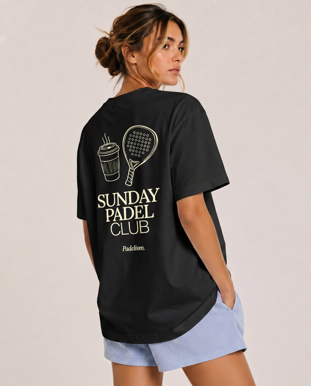 Heavyweight black t-shirt on model, crew neck, large back “Sunday Padel Club” graphic