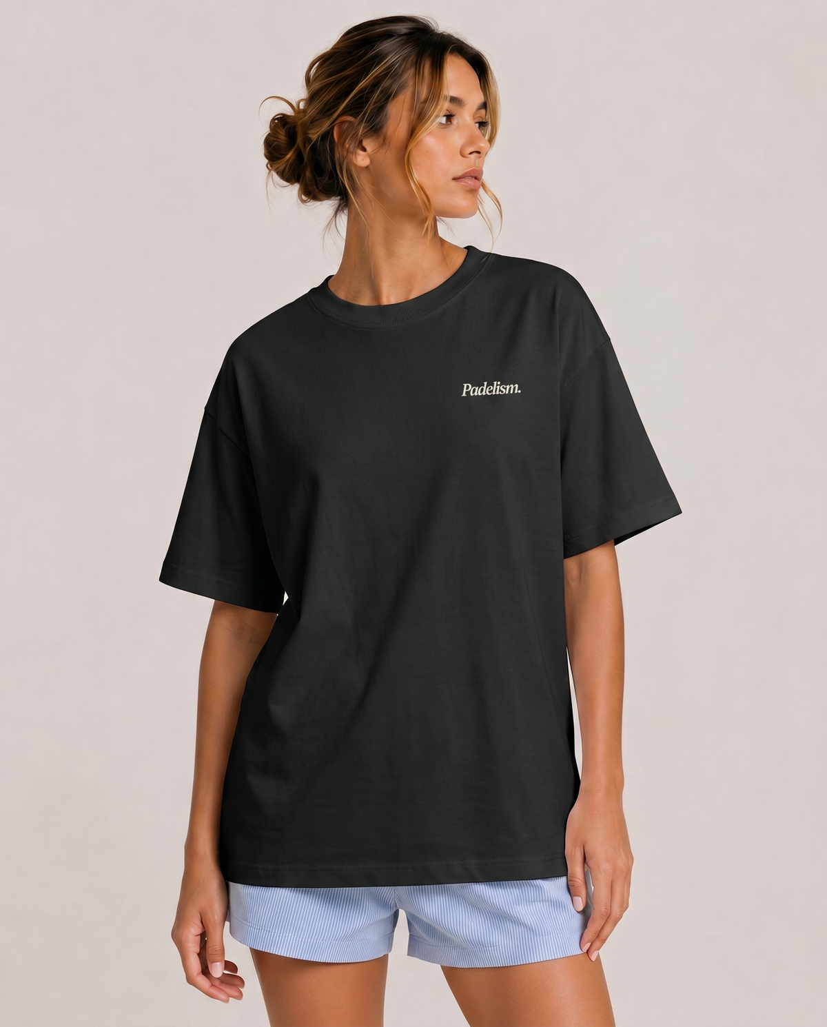 Heavyweight black t-shirt on model, crew neck, small chest logo print