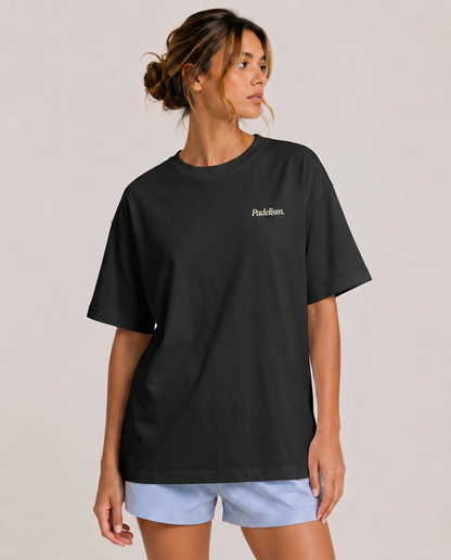 Heavyweight black t-shirt on model, crew neck, small chest logo print
