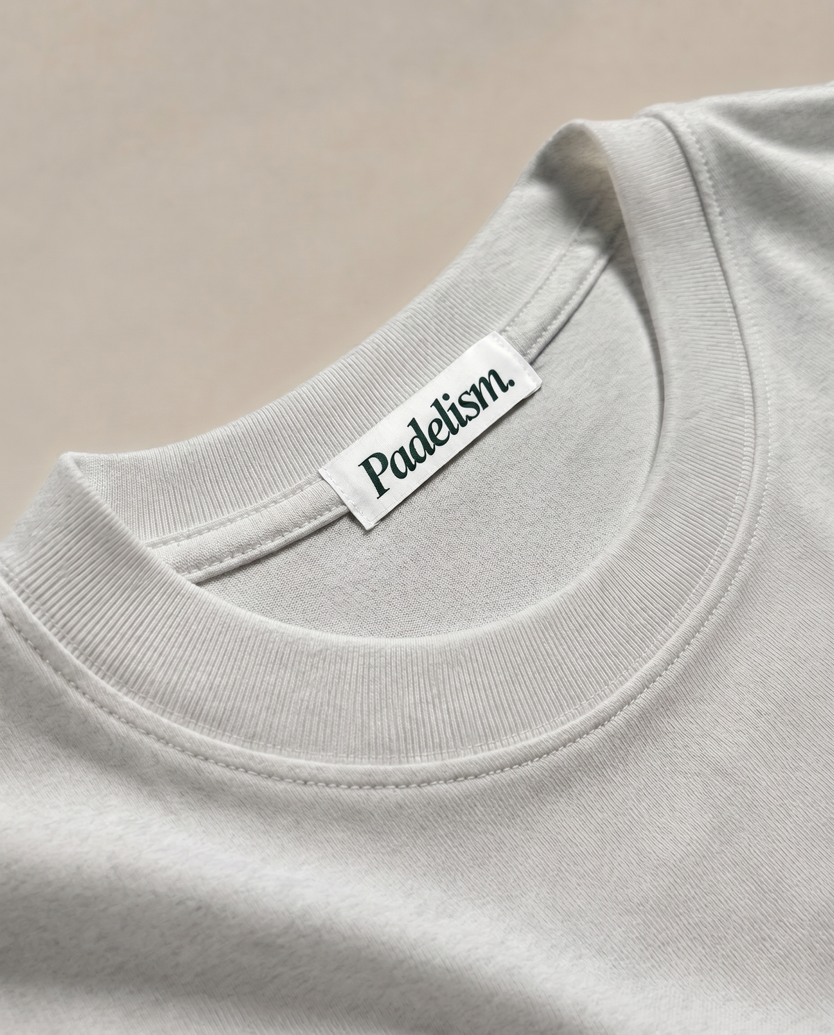 Light gray heavyweight T-shirt with crew neck seam and woven brand neck label