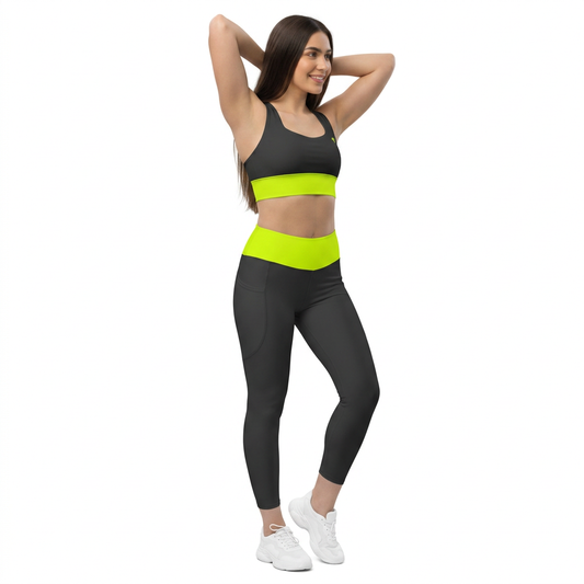 Model wearing the Luminous Surge Summit Yellow sports bra and black pocket leggings with neon yellow bands.
