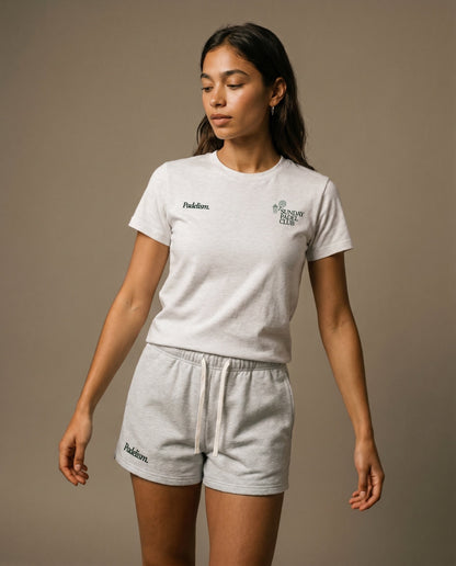 White crewneck t-shirt with small chest logo prints on the front.