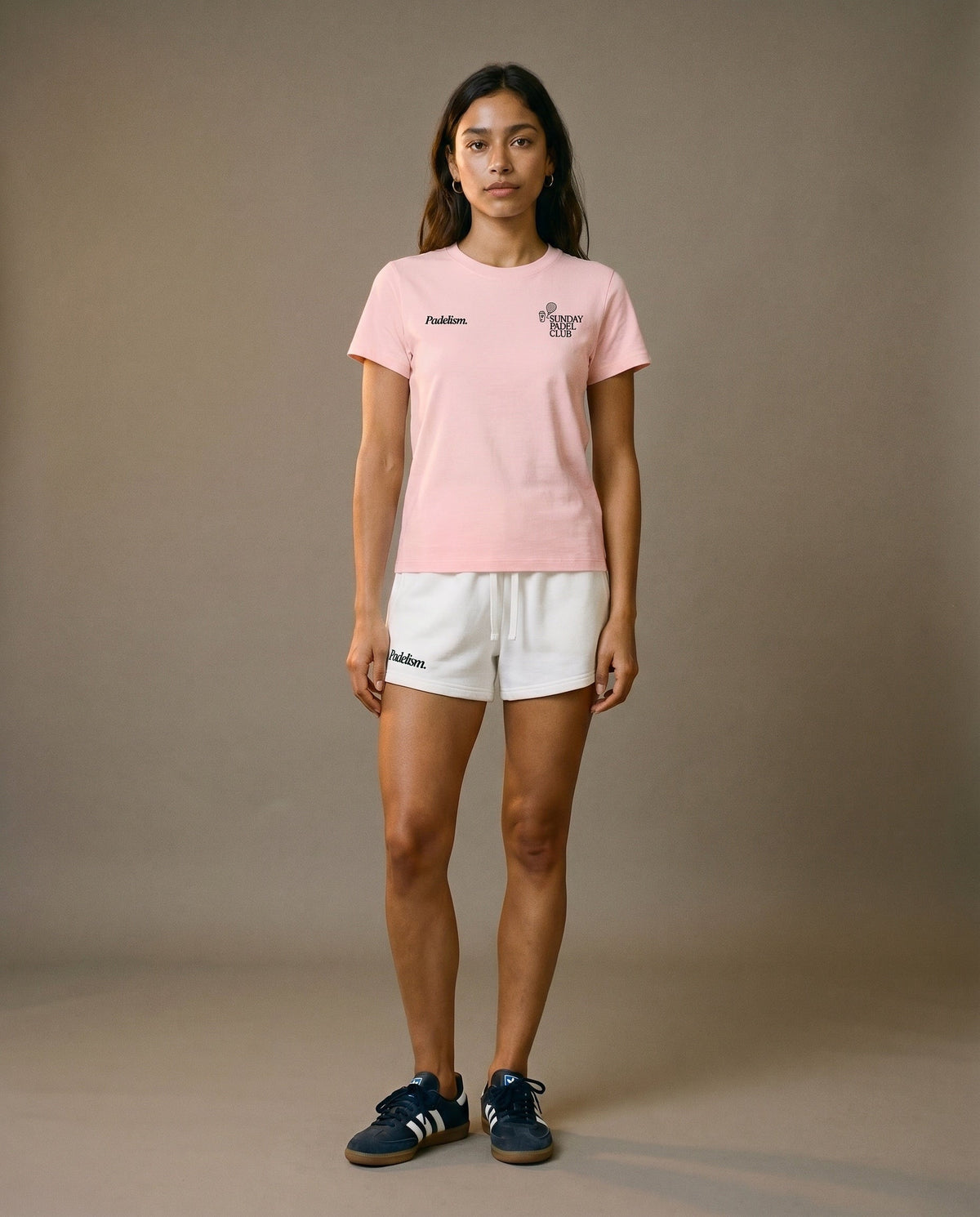 Pink crewneck short-sleeve t-shirt with chest prints, paired with white drawstring shorts