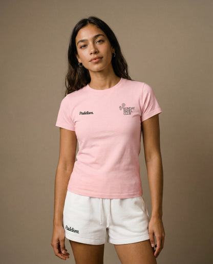 Pink crewneck short-sleeve t-shirt with chest prints, worn with white drawstring shorts