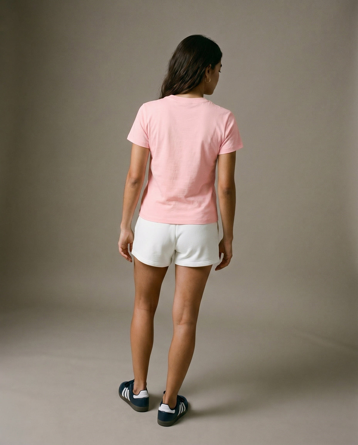 Pink crewneck short-sleeve t-shirt from the back with white drawstring shorts