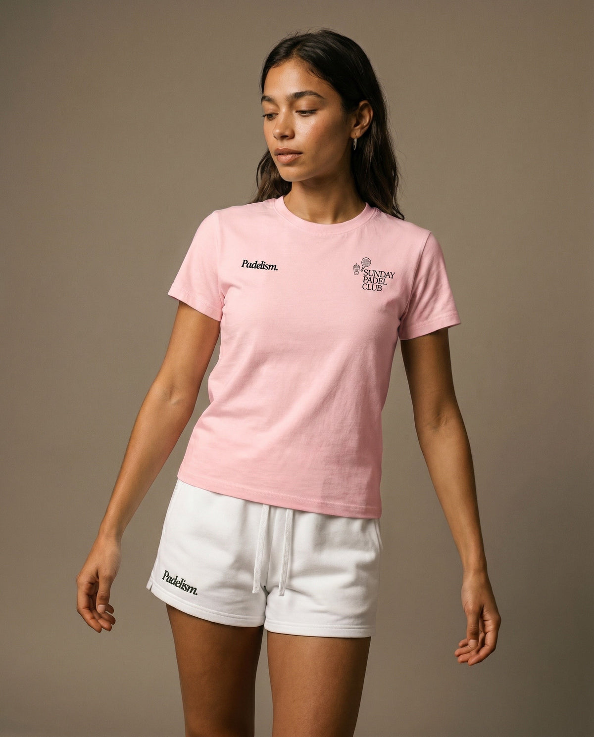 Pink crewneck short-sleeve t-shirt with chest prints, worn with white drawstring shorts