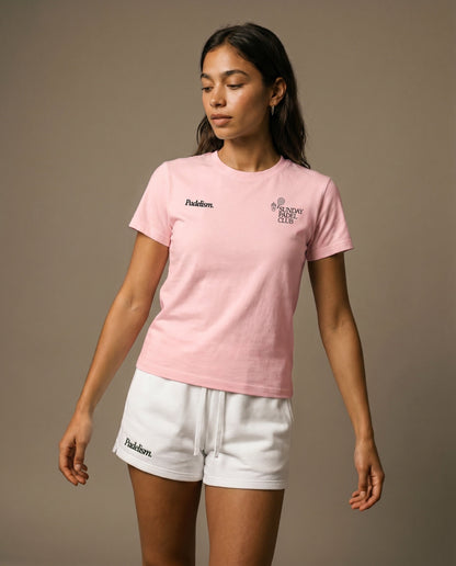 Pink crewneck short-sleeve t-shirt with chest prints, worn with white drawstring shorts