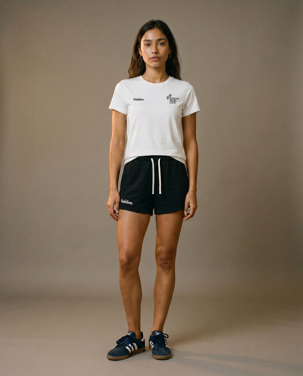White crewneck short-sleeve t-shirt with chest prints, paired with black drawstring shorts