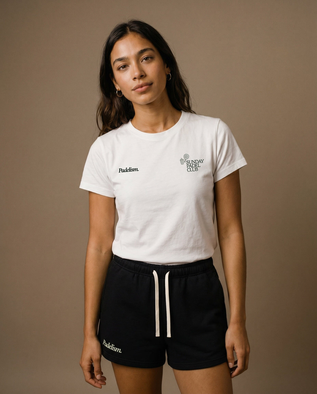 White crewneck short-sleeve t-shirt with chest prints, worn with black drawstring shorts