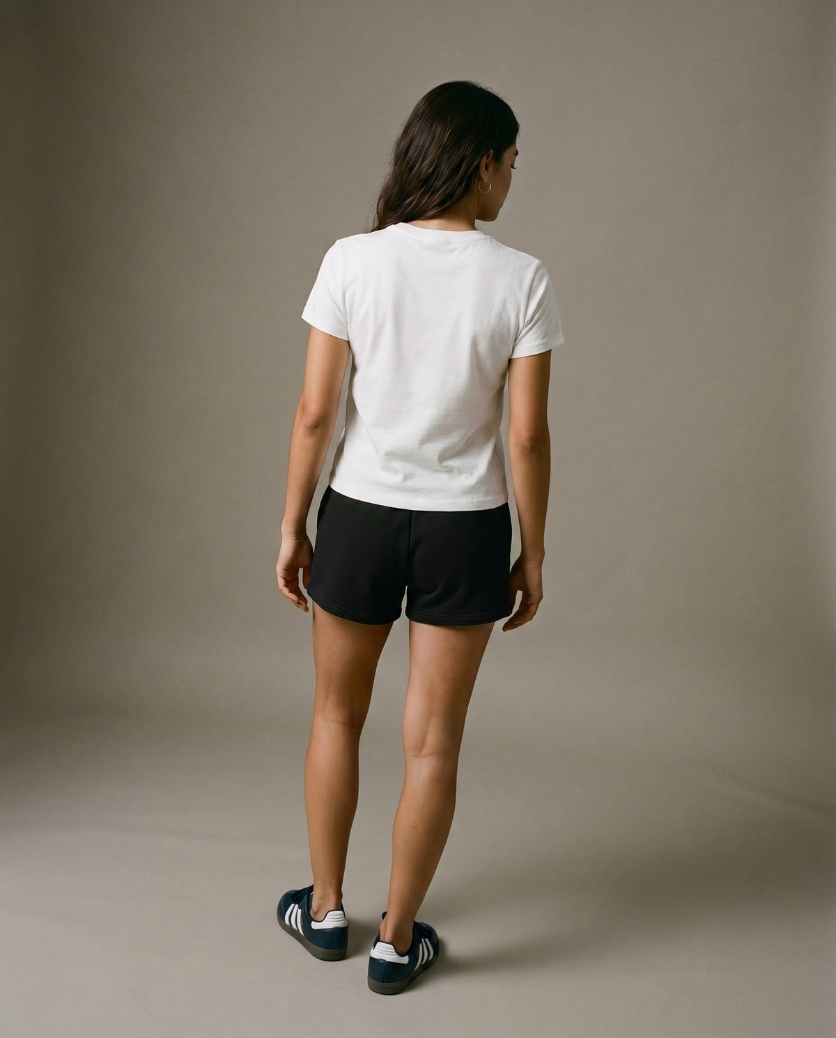 White crewneck short-sleeve t-shirt from the back with black drawstring shorts