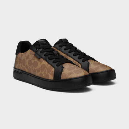 Pair of brown and black low-top trainers with black lace-up design and rubber soles
