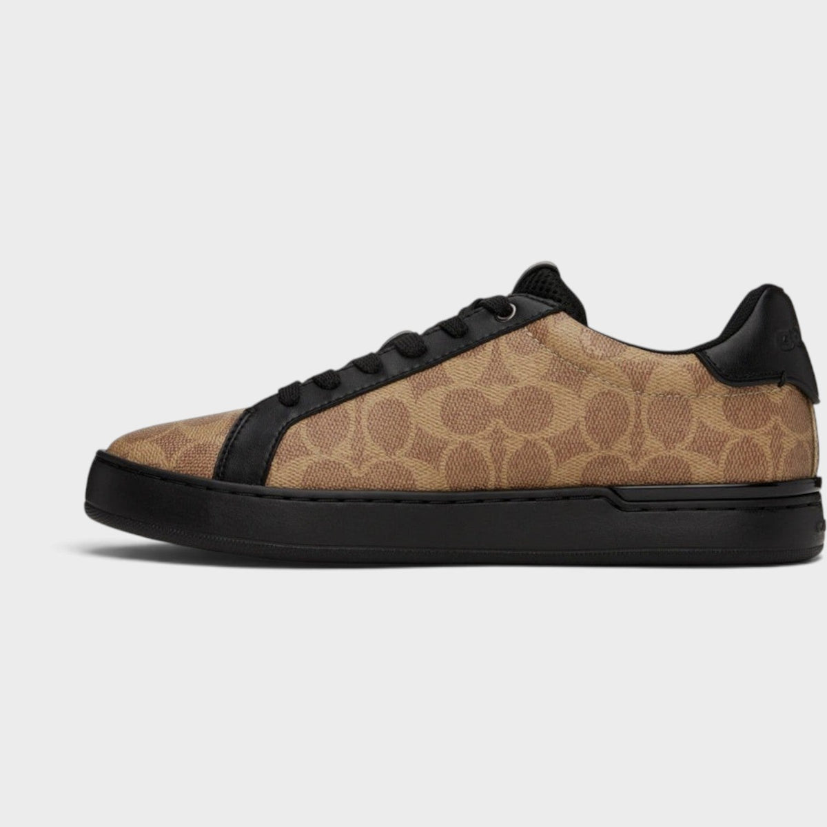 Brown and black low-top trainers, side view with black laces and chunky sole