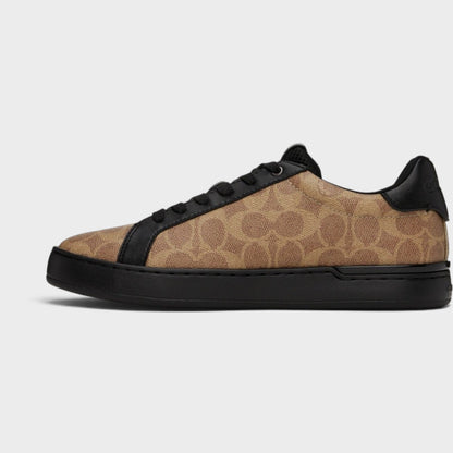 Brown and black low-top trainers, side view with black laces and chunky sole