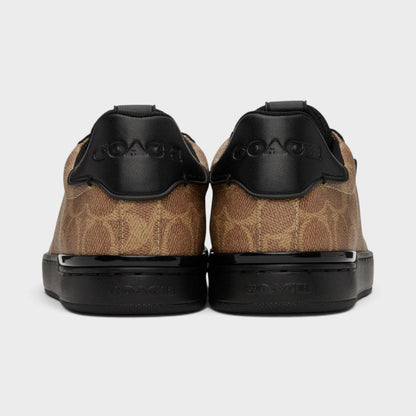 Back view of brown and black low-top trainers with black heel panels and rubber sole
