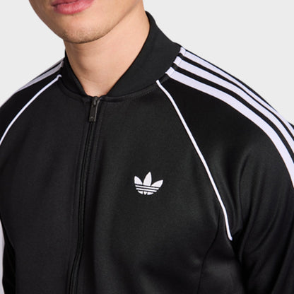 Black track jacket close-up with full-zip, trefoil logo, and white triple stripe details