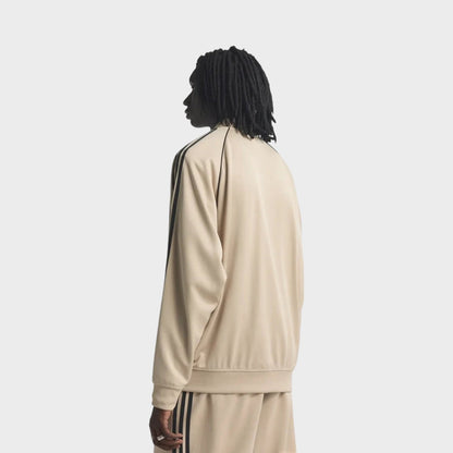 Beige adidas track jacket, back view with black shoulder stripes and elastic hem