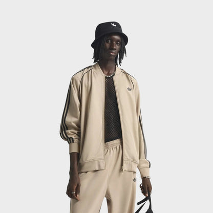 Beige adidas track jacket with stand collar, zipper front, and black sleeve stripes
