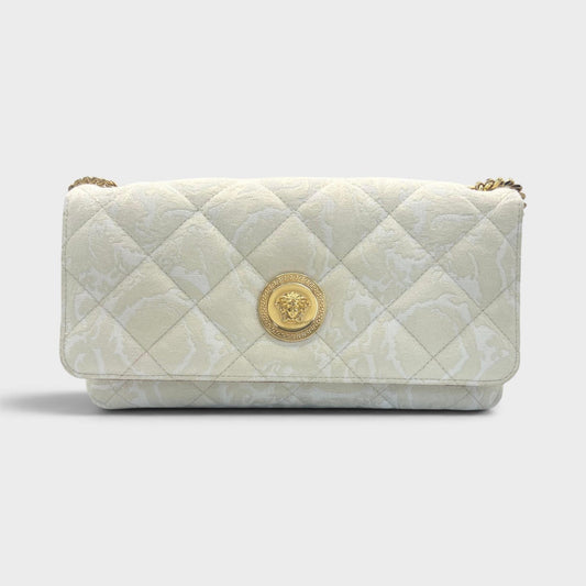 Beige quilted shoulder bag with gold Medusa head emblem and flap closure