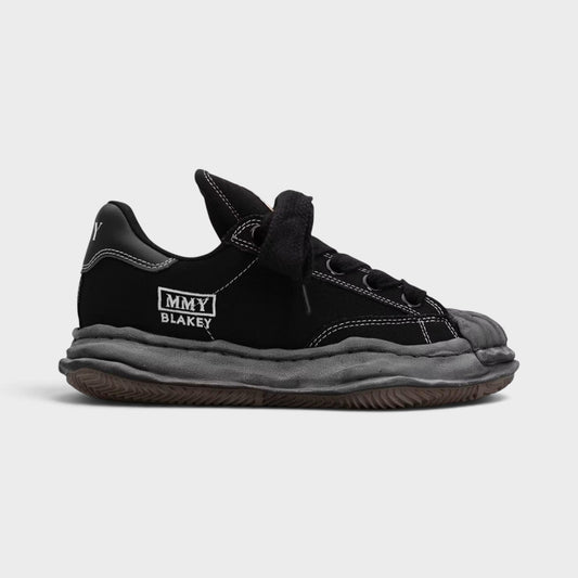Black low-top canvas sneakers, lace-up with chunky puffer sole and MMY BLAKEY logo.