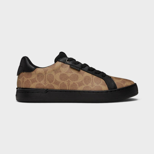 Brown and black low-top trainers with black laces and textured rubber sole