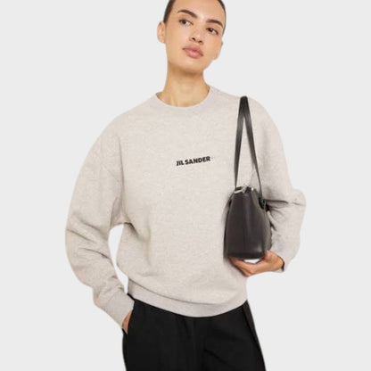 Light grey crewneck sweatshirt with chest logo and ribbed cuffs