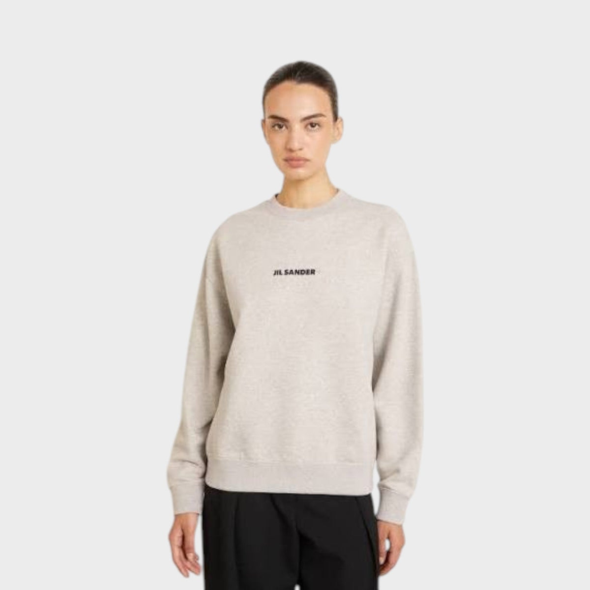 Light grey crewneck sweatshirt with centered chest logo and ribbed hem