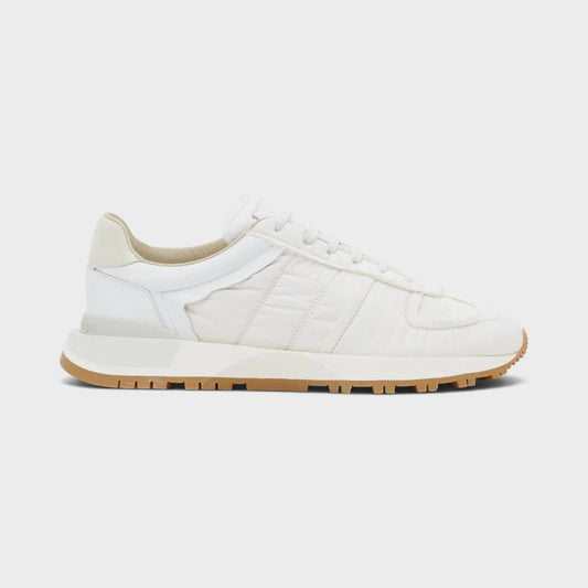 White low-top sneakers with lace-up front and tan rubber sole