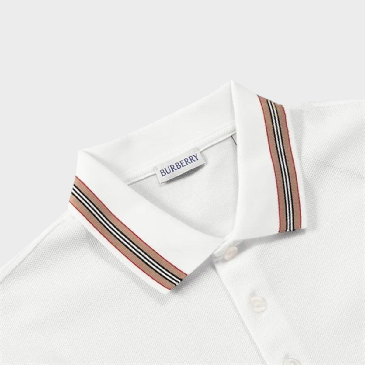 White polo neckline with multicolor striped collar facing and Burberry label.