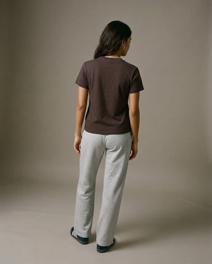 Brown crewneck t-shirt with short sleeves, worn with light gray sweatpants.