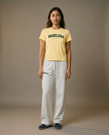 Yellow crewneck T-shirt with Padelism logo, paired with light gray lounge pants