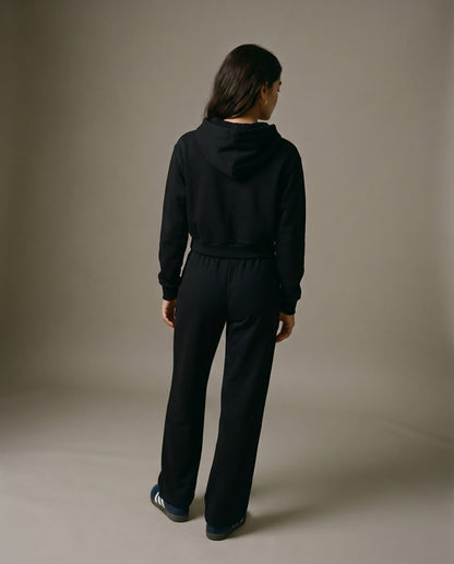 Black cropped hoodie with hood, shown from the back