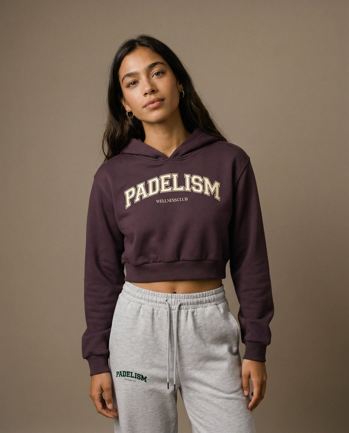 Cropped pullover hoodie in dark reddish purple with front logo print and hood