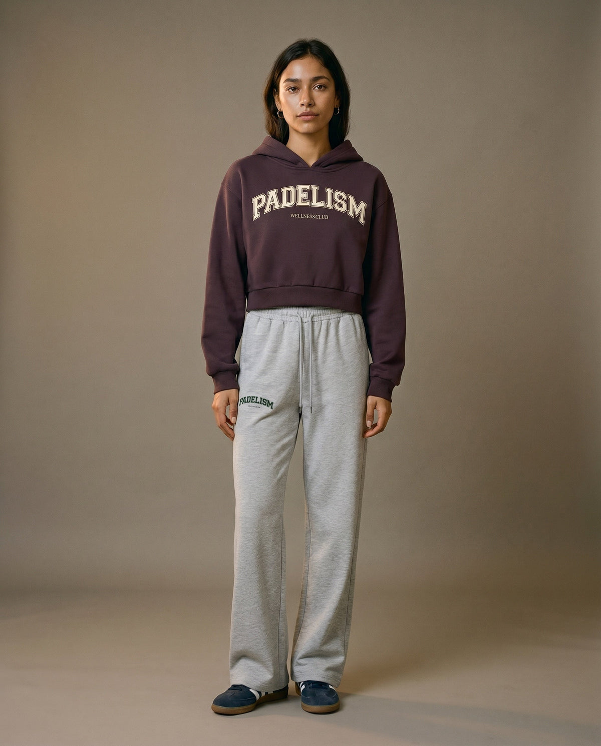 Cropped pullover hoodie in dark reddish purple with hood and front logo, long sleeves